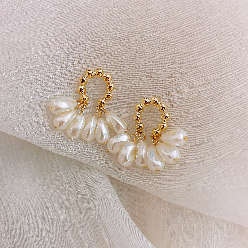 Bonnie baroque pearl earrings laid on fabric