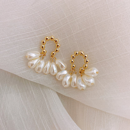 Bonnie baroque pearl earrings laid on fabric