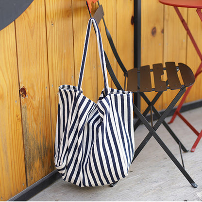 Alba striped canvas shopper hanging on a chair