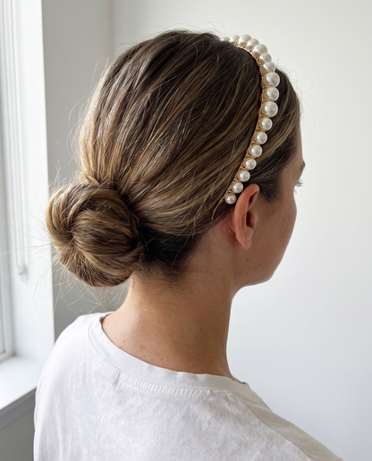 Flora pearl headband worn over a low bun