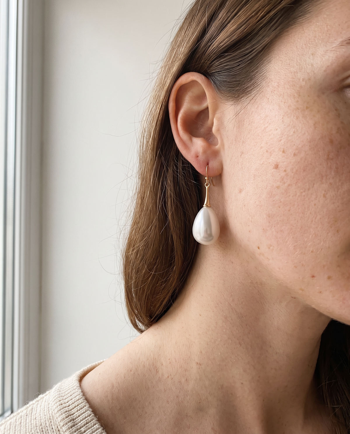 Edie pearl drop earring worn, long length